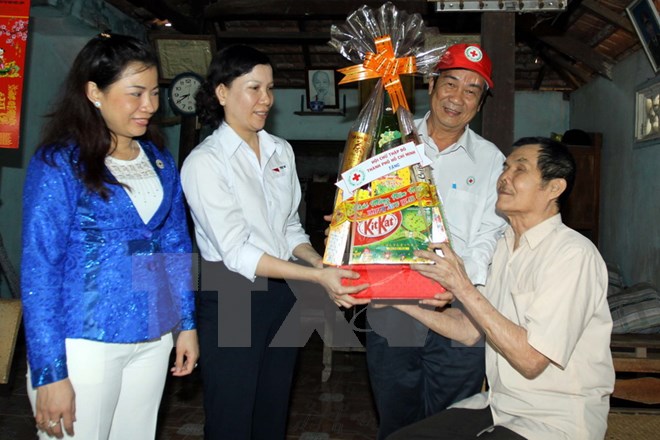 Thăm và tặng quà Tết cho thương binh 1/4 Lê Thanh Cần cùng người con là nạn nhân chất độc da cam ở ấp Ba Sa, xã Phước Hiệp, huyện Củ Chi. (Ảnh: Thanh Vũ/TTXVN)