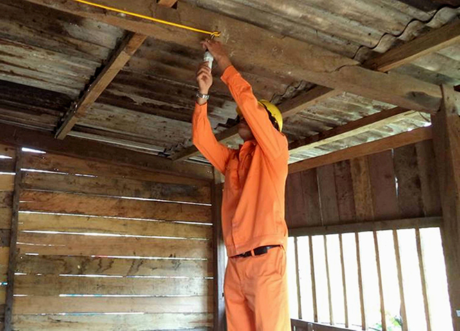 Ngoài việc thu tiền điện, những người “lính áo cam” còn giúp dân bản sửa những vật dụng hư hỏng trong nhà như bóng điện, quạt, ti vi...