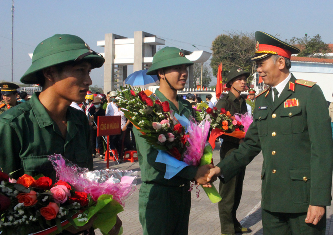  Đồng chí Thiếu tướng Nguyễn Đức Hóa, Ủy viên Thường vụ Đảng ủy, Phó Chính ủy Quân khu IV tặng hoa, quà và bắt tay tân binh trong lễ giao nhận quân.