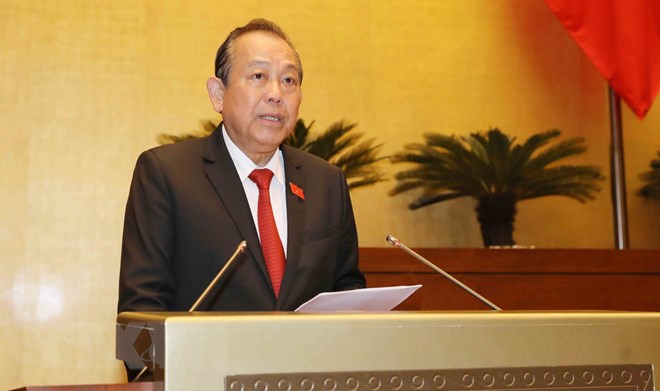 Phó Thủ tướng Thường trực Chính phủ Trương Hòa Bình trình bày Báo cáo việc thực hiện các nghị quyết của Quốc hội về hoạt động giám sát chuyên đề, chất vấn tại kỳ họp từ đầu nhiệm kỳ đến hết kỳ họp thứ tư, Quốc hội khóa XIV. (Ảnh: Phương Hoa/TTXVN)